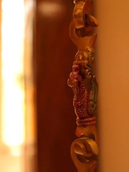 A close-up of a custom-designed, ornate brass chain for a traditional swing, showcasing our commitment to detailed craftsmanship.