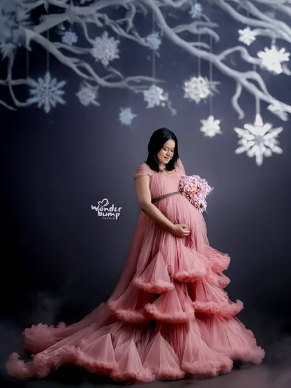 A themed winter wonderland portrait. We use props and creative backdrops, like these snowflakes, to build a unique and magical scene for your photoshoot.