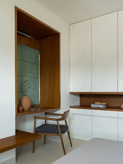 A close-up of the study nook, featuring a wooden desk and chair set within a recessed alcove, creating a cozy and defined workspace.