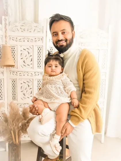 A sweet father and daughter portrait. The simple, bright background keeps the focus on the loving bond between them.
