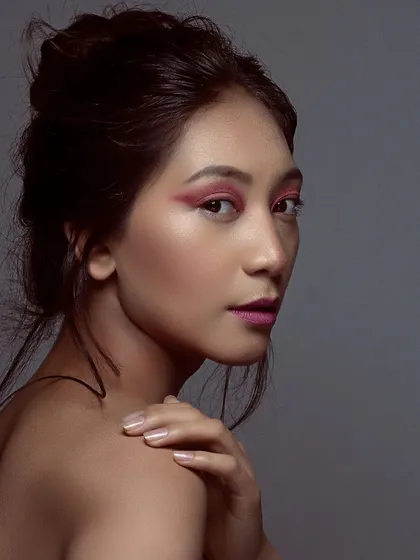 A beautiful portrait showcasing the blend of the pink eyeshadow. This type of creative makeup is perfect for beauty editorials or for a model's portfolio to show their versatile range.