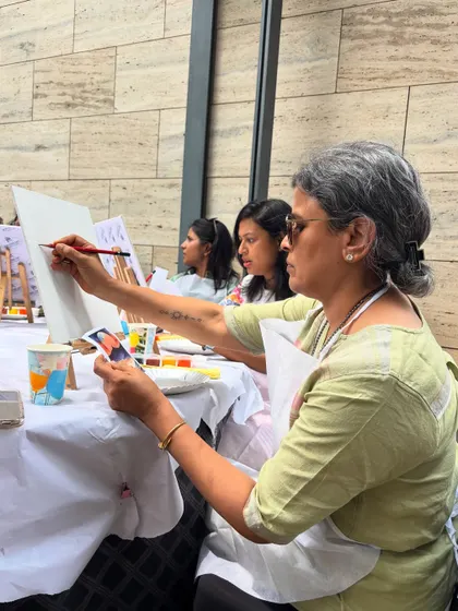 An artist at work, referencing a photo as she paints. Even beginners can create something amazing with a little guidance.