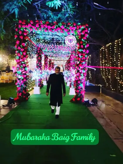 A guest at the Mubaraka Baig family wedding, walking down a beautifully lit and decorated path. Every detail is considered to create a memorable experience.