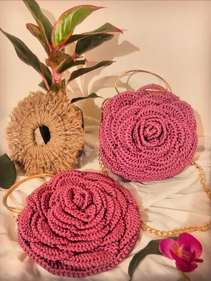 A pair of dusty pink Rose Bags, styled with a plant for a fresh, natural feel. Each one is a piece of art.