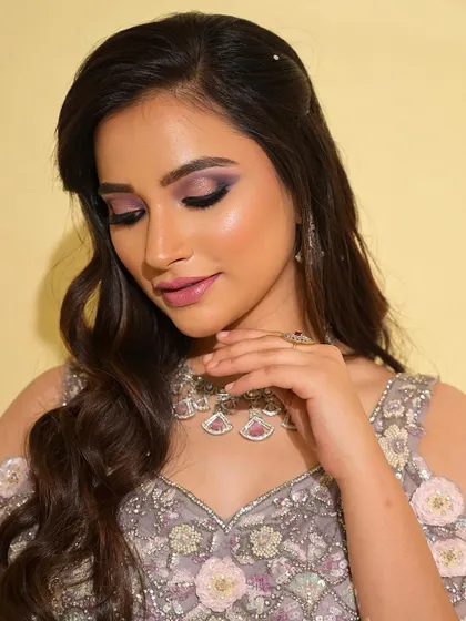 A close-up of the dreamy purple and pink eye makeup. The colors are blended to create a soft, romantic look that is both eye-catching and elegant.