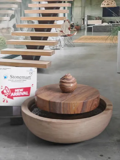 A different perspective of the modern lily pond fountain, showing its placement in a contemporary interior setting.