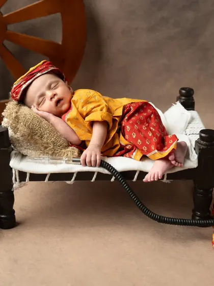 A full view of the vintage Rajasthani setup, complete with a hookah and traditional shoes.