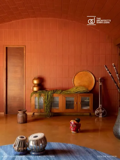 A closer look at the living space in the Madhura house, where traditional Indian instruments feel right at home against the backdrop of earthy textures and materials.