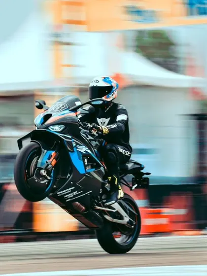 Another shot of the BMW wheelie, capturing the speed and precision of the rider.