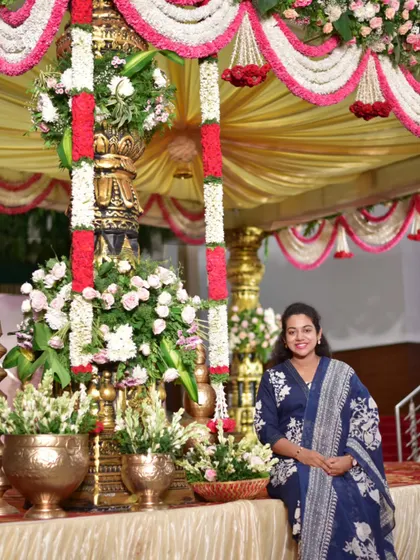 Me, next to a grand wedding mandap we built. I believe success comes from what you do consistently, not just occasionally.