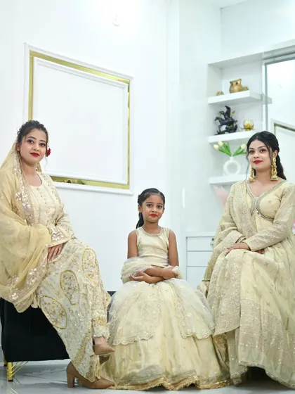Another shot of the family in their matching ivory and gold ensembles, perfect for creating coordinated looks for weddings and festive events.