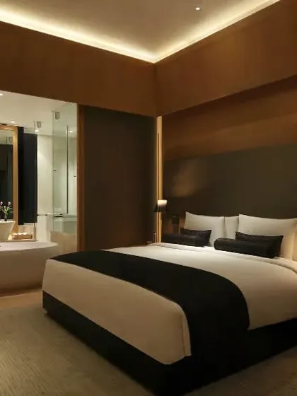 This view shows the layout of one of our luxury rooms, where the bedroom and bathroom spaces flow into each other, creating a sense of openness and modern comfort.