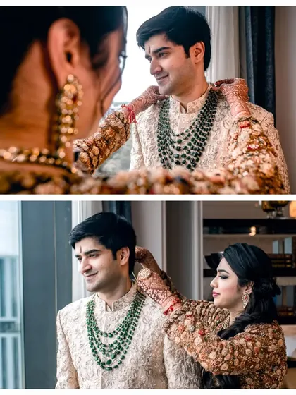 A family member helping the groom with his necklace, a beautiful moment of care and attention before the ceremony.