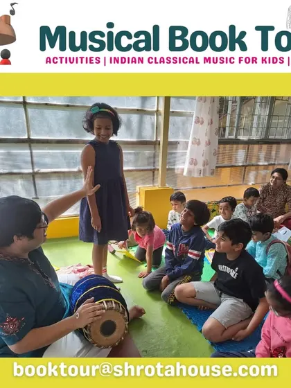 A child gets a turn to play the Mridangam, a key percussion instrument in Carnatic music. Our workshops often feature guest musicians who introduce their specialized instruments.