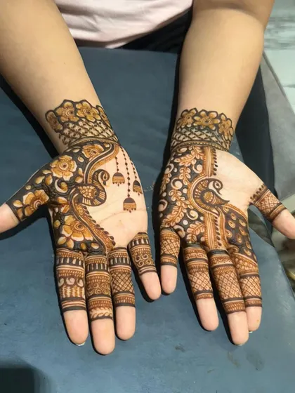 A beautiful peacock design for a guest, with delicate jhumka details.
