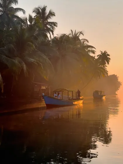 A boat docked in the misty, golden light of sunrise in Honnavar. A truly breathtaking and photographic moment.