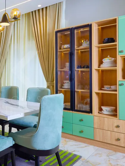 Another view of the crockery unit, highlighting the combination of mint green and natural wood finishes.