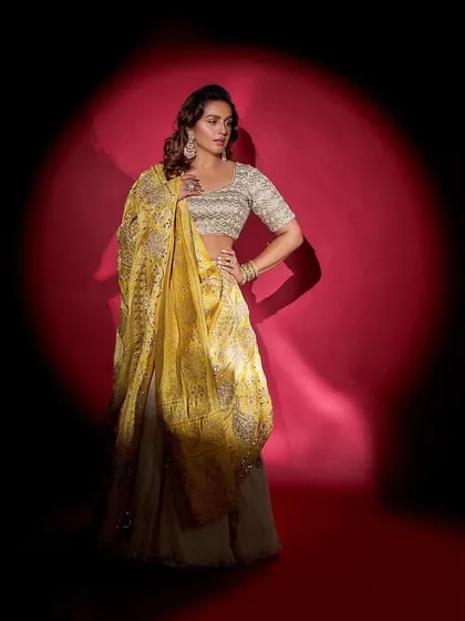 Another shot of the gorgeous Faabiiana lehenga. The dramatic lighting highlights the intricate work on the dupatta and the elegant silhouette.