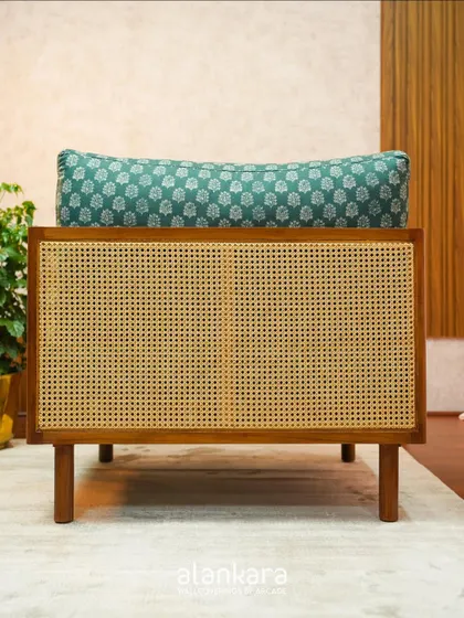 Another shot of the back of the teak and cane armchair, emphasizing the beautiful craftsmanship.