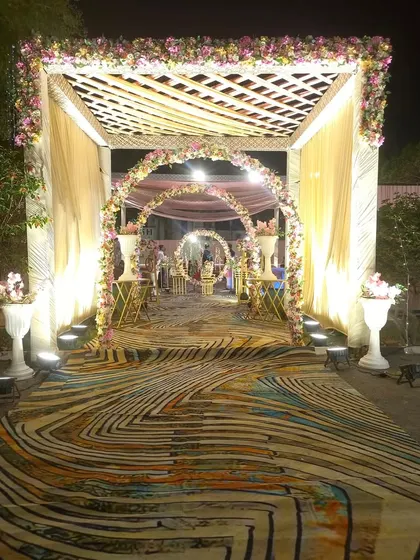 A closer look at the layered entrance design with a wooden trellis, floral arches, and a vibrant printed carpet. This setup shows how I combine different textures and elements for a rich visual experience.