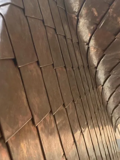 A close-up of the handcrafted copper shingle work from a farmhouse project in Hassan. This detail highlights my commitment to using skilled artisans and natural materials that age gracefully, adding character and warmth to the building over time.
