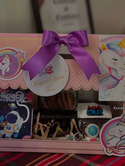 This is our popular Unicorn and Space themed hamper, a perfect return gift for kids' birthdays. It includes a mix of items like cookies, stationery, and a personalized thank you card, all beautifully packaged.
