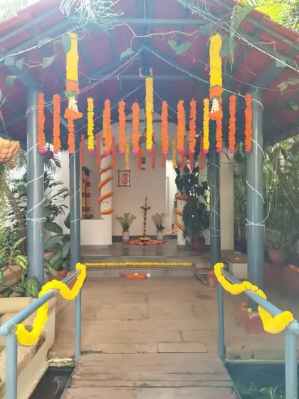 Another view of the entrance decorated with hanging marigold garlands, showing how we use simple, traditional elements to create a beautiful and welcoming atmosphere.