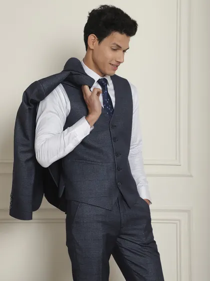 The three-piece construction of our navy suit, showing the versatility of wearing it with or without the jacket.