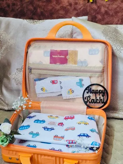 This version of the suitcase hamper is filled with car-themed baby items, showing how I can customize the contents for different ages and interests.