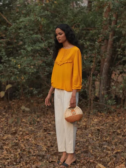 A similar shot with a slightly different pose, capturing a sense of calm and connection with nature. This type of imagery is perfect for brands that emphasize sustainability and organic materials.