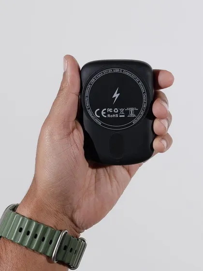 An in-hand shot of the Urbn power bank to show its compact size and portability. This helps customers understand the product's scale and how it feels to use.