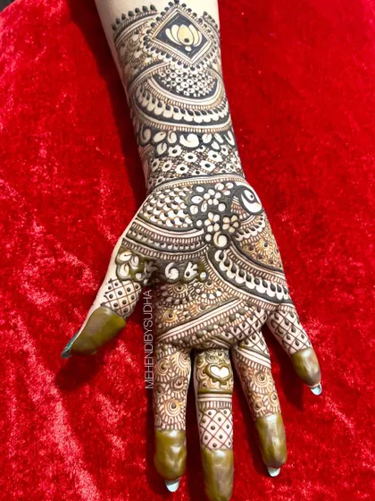 A single hand from a bold engagement design, featuring a prominent lotus motif on the forearm.