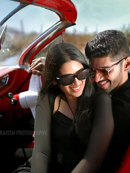 A happy, relaxed moment between the couple in the front seat of the classic car. This pre-wedding photo feels natural and unposed, focusing on their genuine smiles.