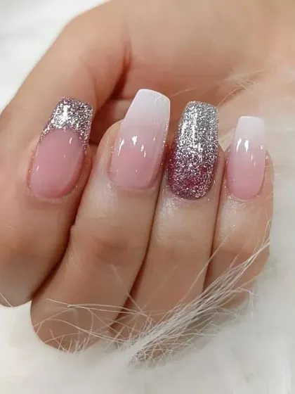 A beautiful combination of pink and white ombre with accent nails covered in sparkling silver and pink glitter.