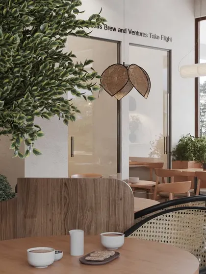 A close-up of the custom seating, where we used a combination of wood and cane weaving. The large indoor plants are housed in custom wooden planters that double as subtle space dividers.