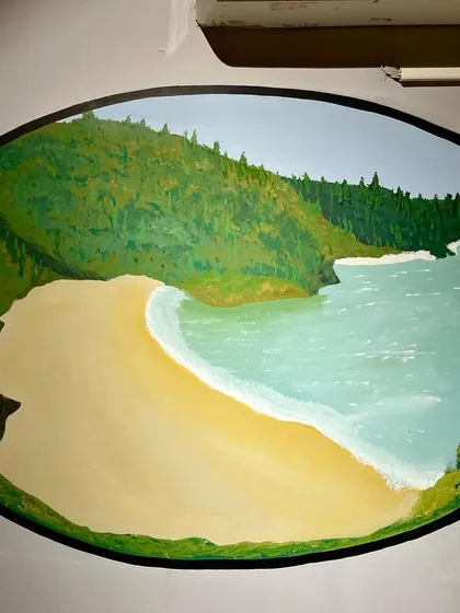 This mural shows a beautiful beach scene, representing coastal cycling routes. Each painting was carefully designed to fit the oval frame and contribute to the store's adventurous theme.