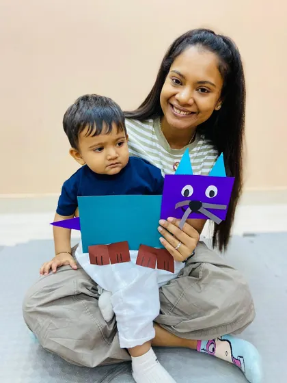 A duplicate of ID 89, this image shows a mother and son with their completed cat craft, a proud moment in our Pitampura class.
