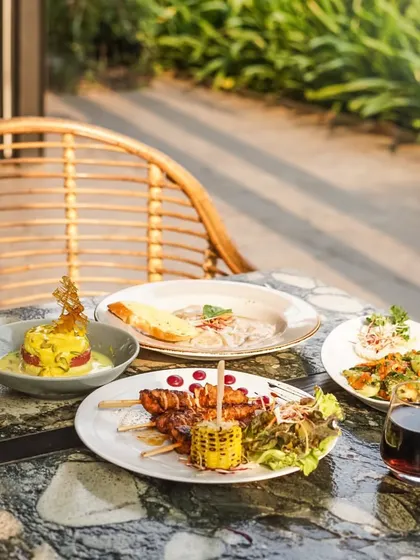 A beautiful spread of our global cuisine, set against the backdrop of our lush garden.