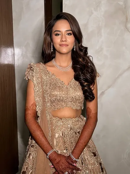 A radiant smile to complete the perfect sangeet glam. Her skin looks flawless and glowing, paired with a soft eye makeup look that enhances her natural beauty.