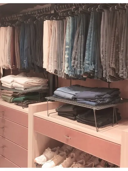 We used a combination of hanging space and shelf risers to organize this pants and jeans collection. This method maximizes storage and keeps everything tidy and easy to access.