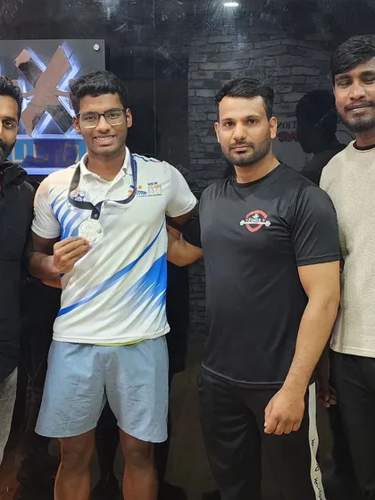 Our training team with silver medalist Nithik. We work collaboratively to provide comprehensive support, from strength coaching to nutrition planning, for our competitive athletes.