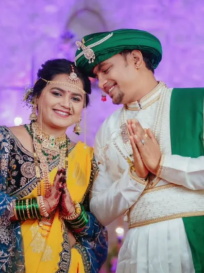 The couple greets their guests with a traditional 'namaste', their happy faces reflecting the warmth of the celebration.