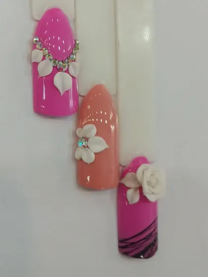 Another view of the 3D nail art samples, showing the variety of shapes and color combinations that can be achieved with this advanced technique.