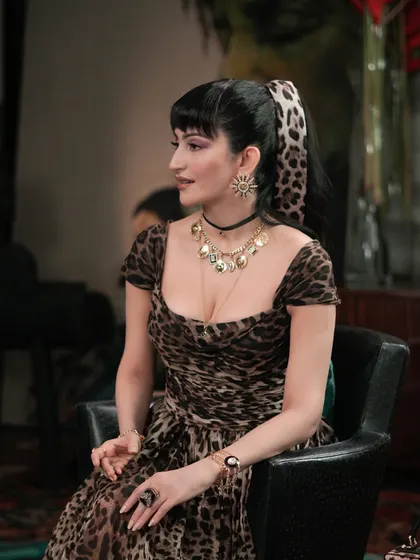 A closer look at the styling for Shalini Passi's leopard print ensemble. The layered necklaces and sunburst earrings were key to achieving this dramatic, high-fashion aesthetic for the Netflix show.
