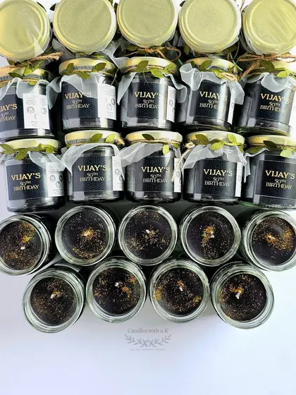 The black soy wax candles with golden glitter, shown with their personalized lids, ready for packing.