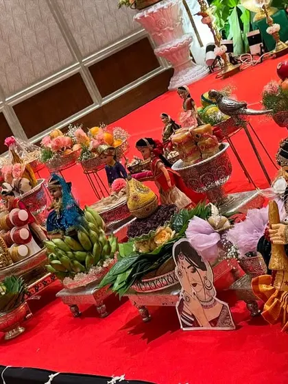 A long shot of a platter display on a red carpet, showing the meticulous arrangement.