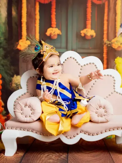 A dynamic shot of our little Krishna, pointing with excitement. I love capturing the energy and personality of each child during their session.