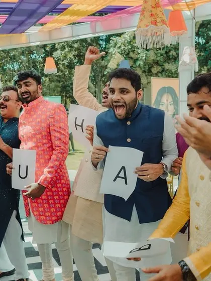 The groom's side having fun with games during the carnival. Capturing the competitive spirit and laughter of these activities is part of documenting the whole wedding experience.