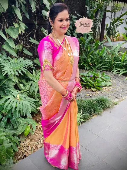 The complete look for the bride's mom, looking elegant in her silk saree. The hairstyle and makeup are timeless and sophisticated.