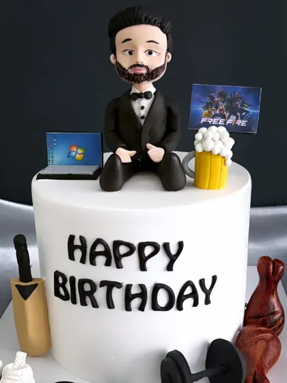 A close-up of the custom-made topper on the hobby cake, showing the detailed figurine.